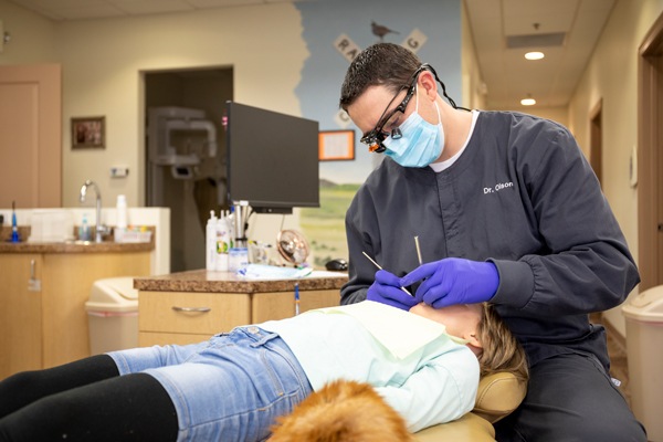 Dentist treating young patient in clinic